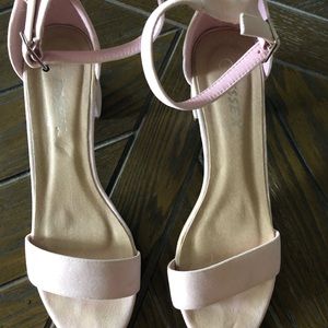 Block heel suede sandals in pale pink.